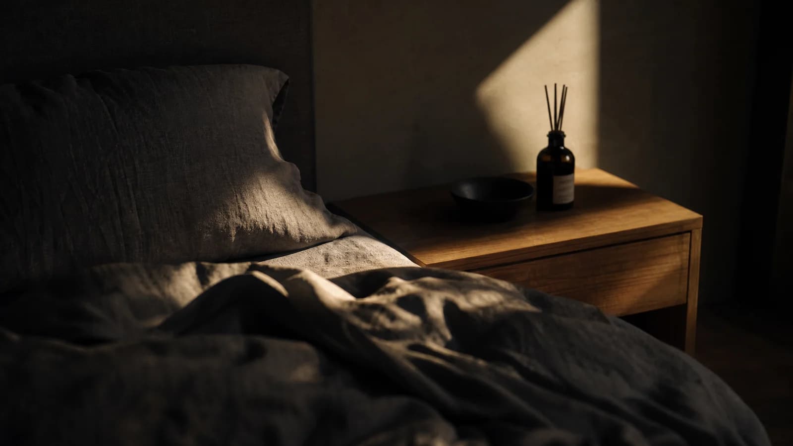 First light across linen in a dark room