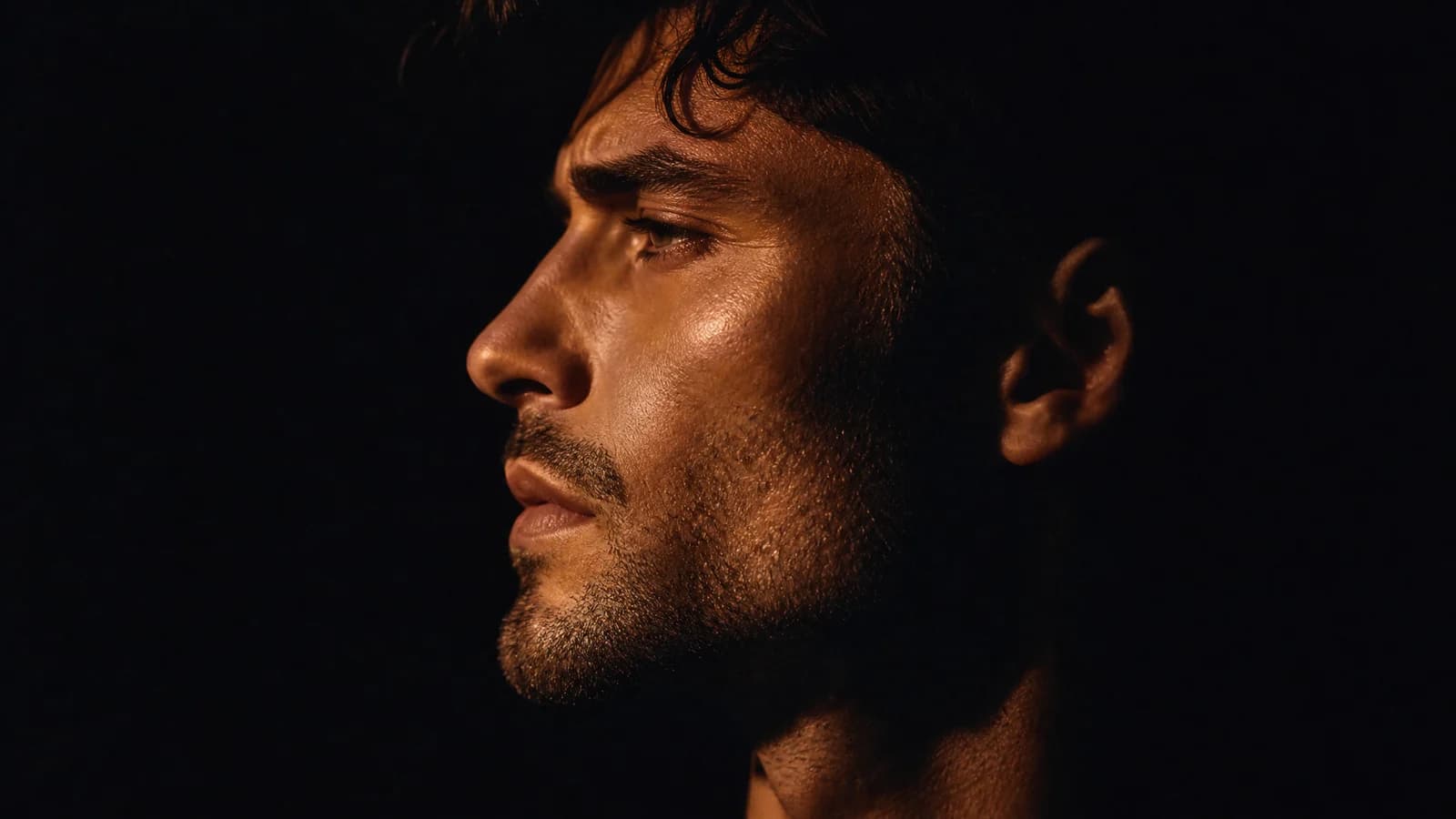 Sharp male jawline and skin in copper light